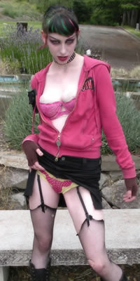 Inkygirl Richard in pink hoodie, miniskirt, garter and stockings, and combat boots